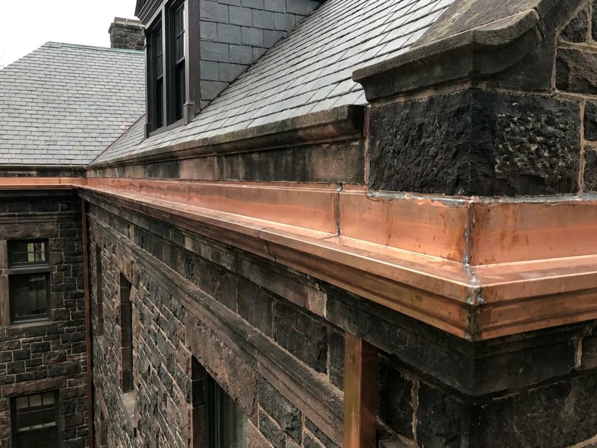 Copper-lined built-in box gutter along a stone cornice