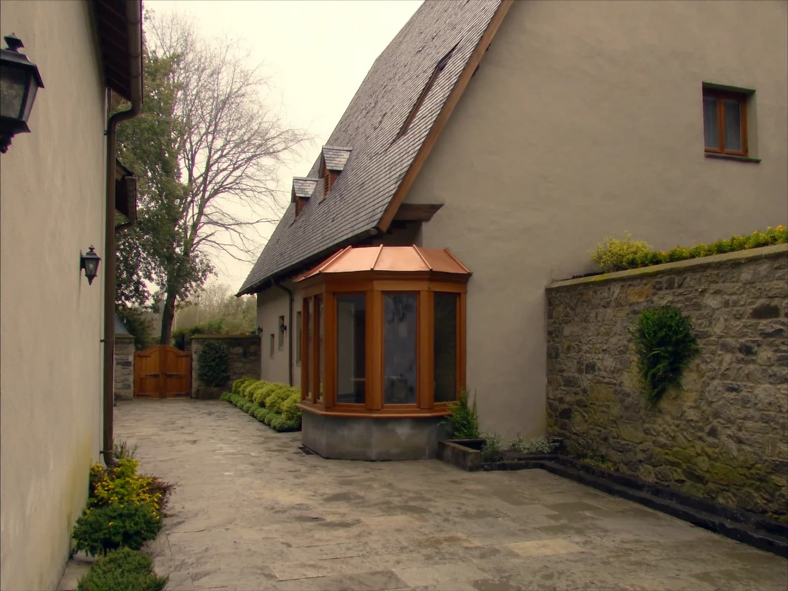 Slate roof over a stone courtyard and side entry